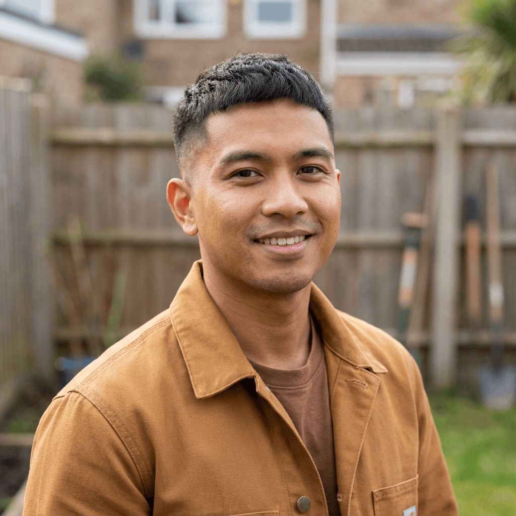 Relieved male homeowner in his 30s standing in a carpeted living room